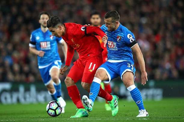 LIVERPOOL, ENGLAND - APRIL 05: Roberto Firmino of Liverpool (L) and Jack Wilshere of AFC Bournemouth (R) battle for possession during the Premier League match between Liverpool and AFC Bournemouth at Anfield on April 5, 2017 in Liverpool, England. (Photo by Clive Brunskill/Getty Images)